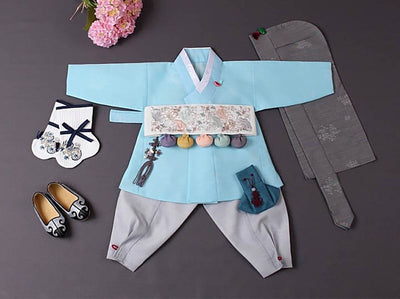 A cute baby boy hanbok in baby blue. This hanbok mimics a modern boys hanbok with the vest and jeogori combined into one.