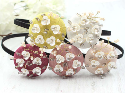 This blossom flower hairband comes in different colors which are sallow, lily white, plum red, rouge, and maroon.