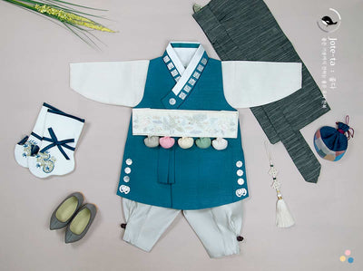 Noble Baby Boy Hanbok in Navy that's designed with traditional Korean patterns and historic Korean characters. This hanbok is dressed with Dol accessories to show off the aesthetic look of the Hanbok for Doljanchi.