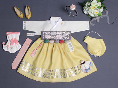 The beautiful baby girl hanbok in yellow & ivory is shown here with accessories we offer to complete the look and bring an even more enchanting aesthetic look to the outfit.