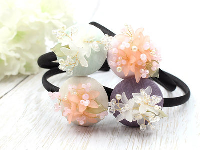 Blossom Flower beads hairband can add a whimsical element to any hair style. You'll be able to purchase this item in mint, maroon, bronze, and coral.