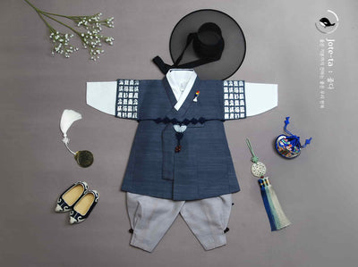 Baby boy hanbok in Charcoal. This shows a unique set of hanbok accessories to turn this boy hanbok into a knight themed one.