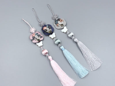 THe White Butterfly & Leaf Tassel Norigae will bring you luck and good fortune whenever you wear it. It's available in cobalt, coral, and slate.