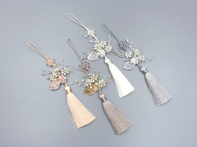 Worn with a hanbok, the Floral Pearl Tassel Norigae will make you feel extra classy. The ornament comes in stone, cream, light gray, dark ivory.